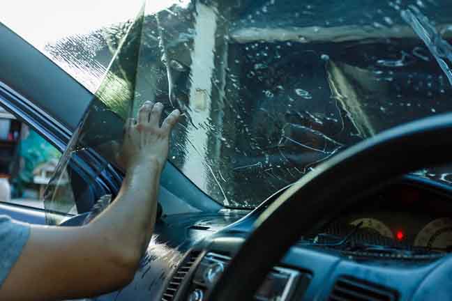 Car Films Installing windshield protection film blur.