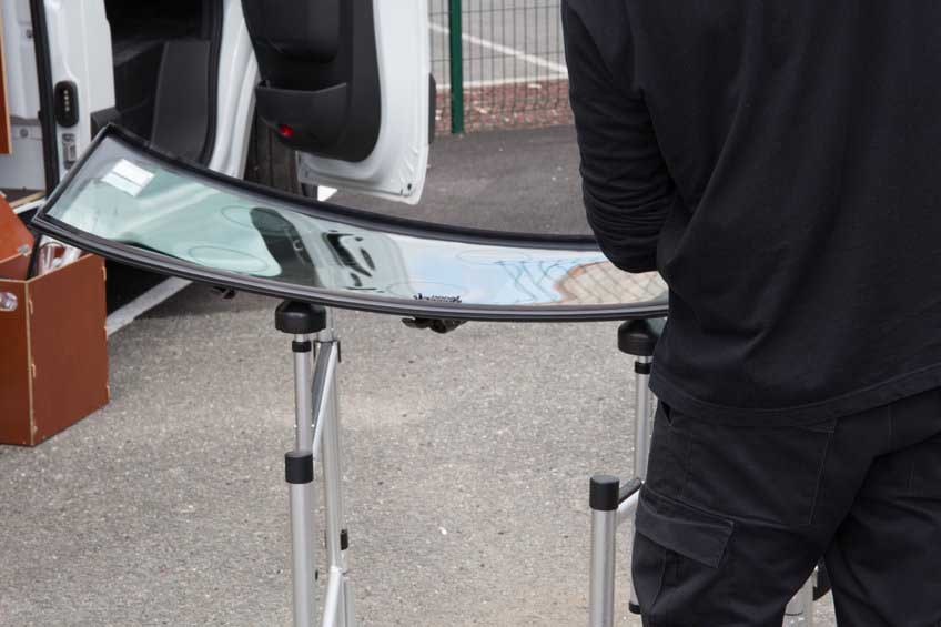 Glazier removing windshield or windscreen on a car