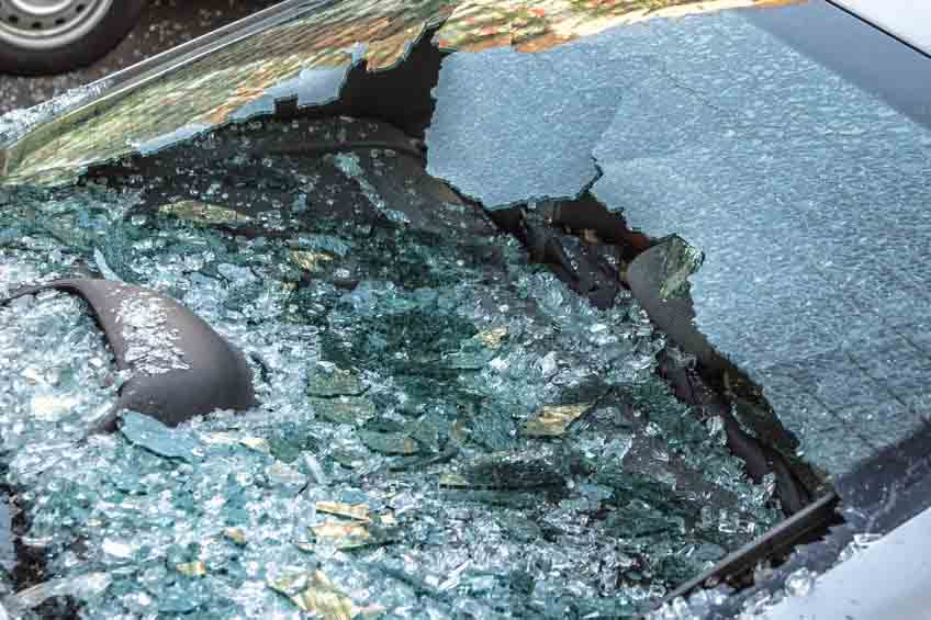 Broken rear glass of car, spread fragments of glass.