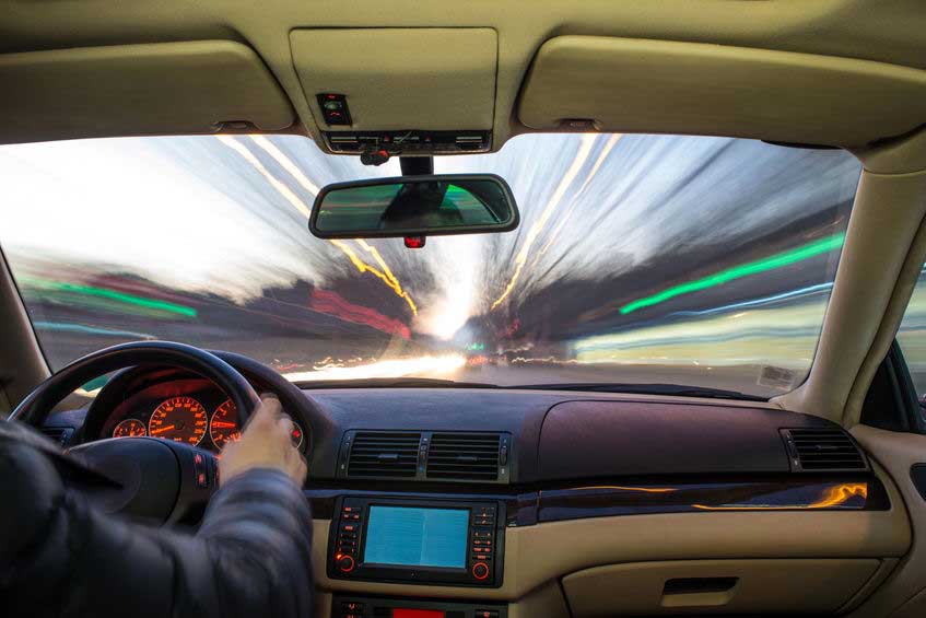 Car interior on driving. Blurred night lights