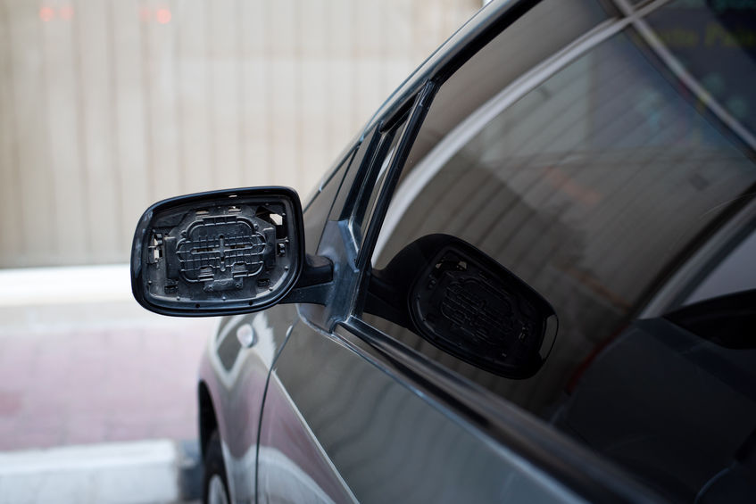 Car with broken rear mirror close up