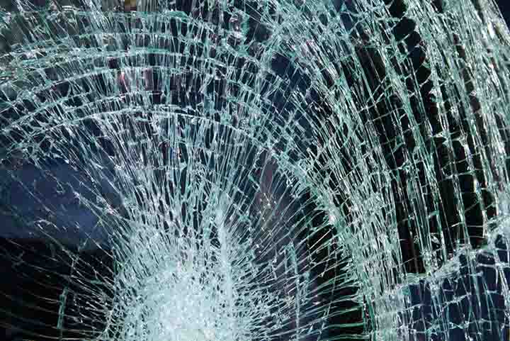 Broken car windshield made of laminated glass Broken car windshield made of laminated glass
