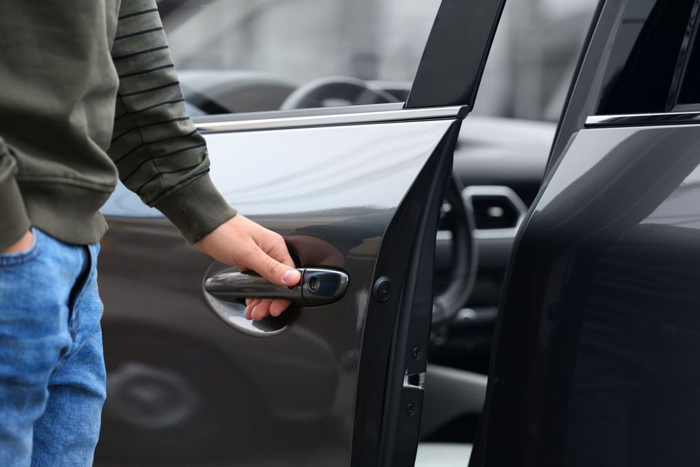 vehicle owner closing car door